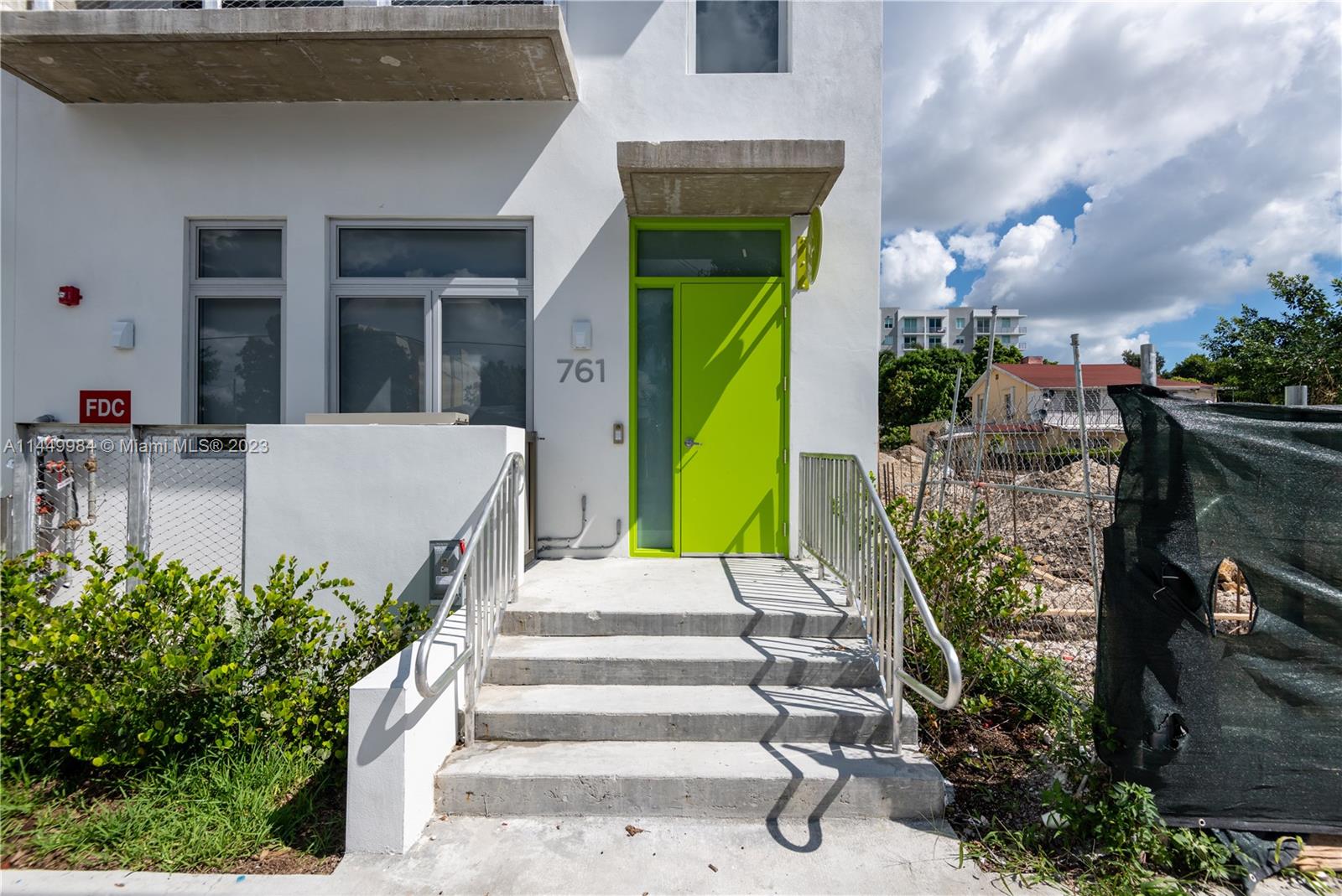 771 Northwest 1st Street, Unit 201 Miami, FL 33128 - Photo 7 of 34 a front view of a house with a garden