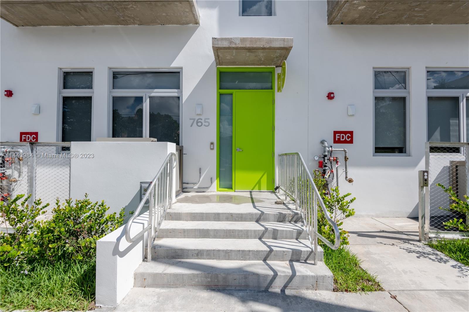 771 Northwest 1st Street, Unit 201 Miami, FL 33128 - Photo 8 of 34 a front view of a house with plants