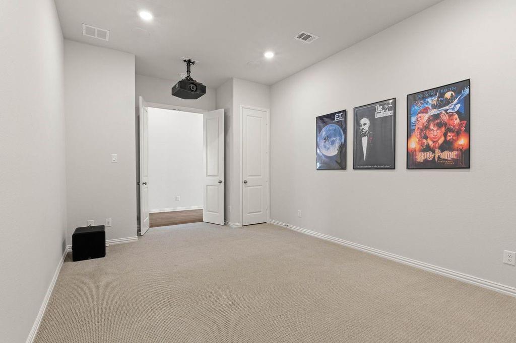 1636 Hydrangea Lane Prosper, TX 75078 - Photo 11 of 31 a view of an empty room with wall painting and a fan