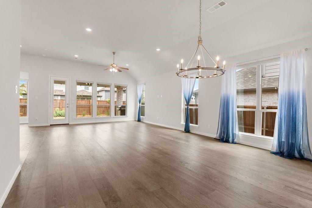 1636 Hydrangea Lane Prosper, TX 75078 - Photo 12 of 31 an empty room with wooden floor and windows