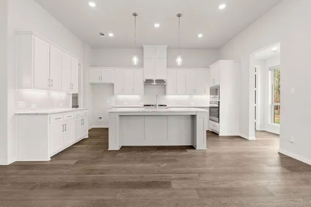 a kitchen with stainless steel appliances granite countertop a stove and a sink