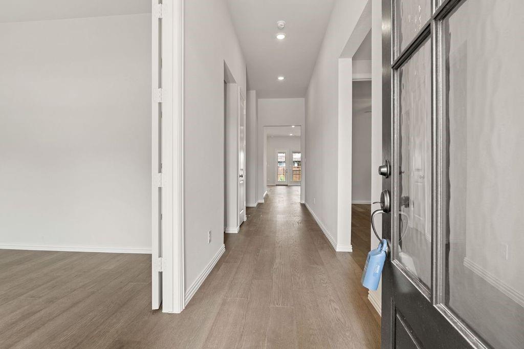1636 Hydrangea Lane Prosper, TX 75078 - Photo 2 of 31 a view of a hallway with wooden floor