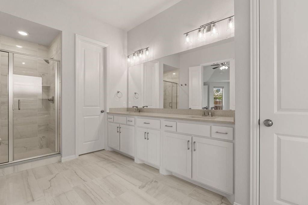 1636 Hydrangea Lane Prosper, TX 75078 - Photo 26 of 31 a spacious bathroom with a granite countertop sink mirror and shower