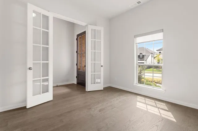 an empty room with windows and closet