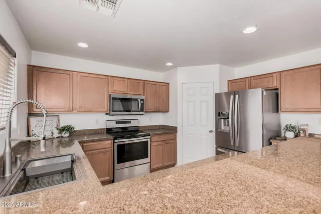 a kitchen with granite countertop a sink and a window
