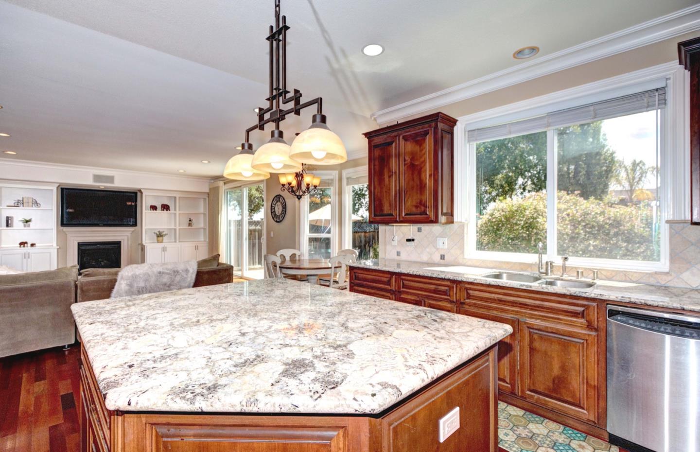 5408 Taft Drive San Jose, CA 95124 - Photo 11 of 26 a kitchen with kitchen island granite countertop wooden cabinets and a refrigerator