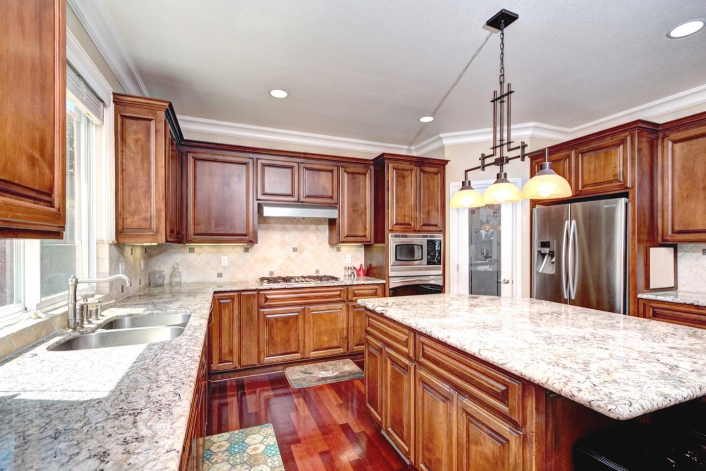 5408 Taft Drive San Jose, CA 95124 - Photo 12 of 26 a kitchen with stainless steel appliances granite countertop a sink a stove and a wooden cabinets