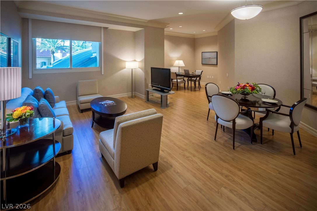 2777 Paradise Road, Unit 807 Las Vegas, NV 89109 - Photo 55 of 61 Blonde wood flooring unifies this open-concept living space, featuring a cozy lounge and elegant dining area.