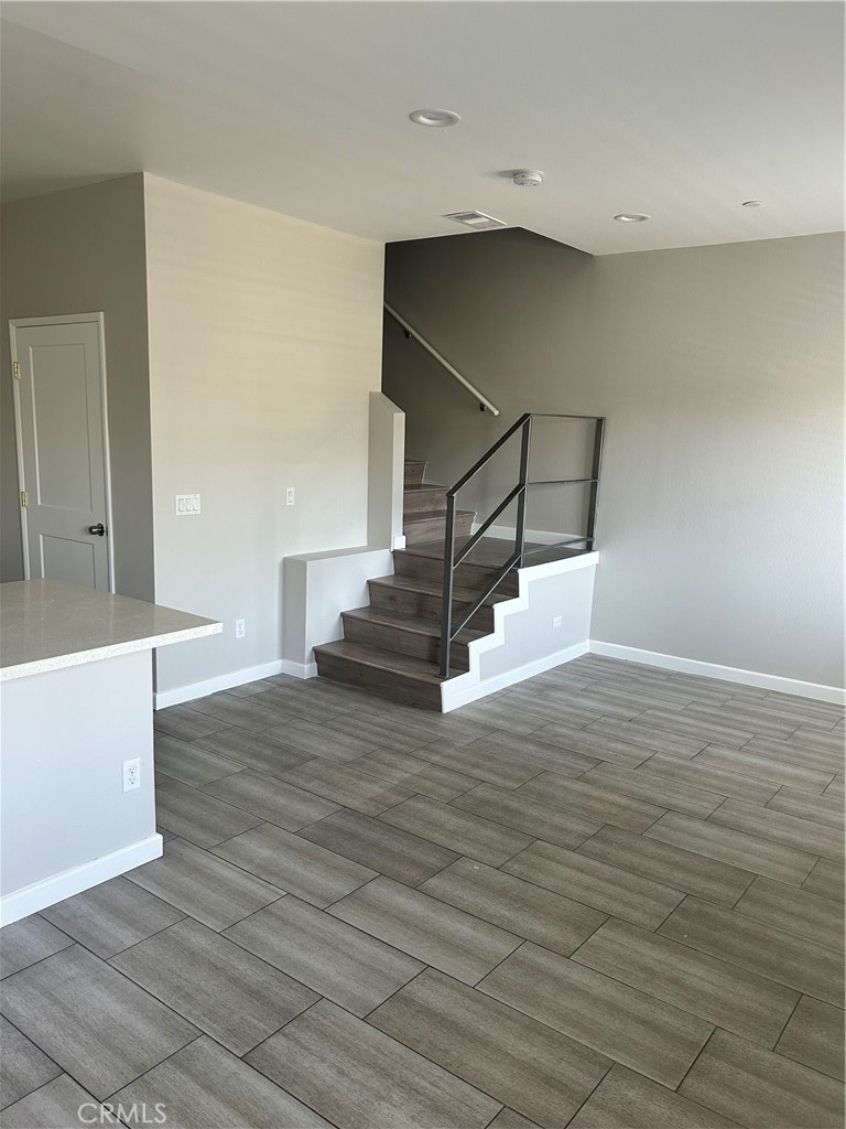 13665 Arrow Route, Unit 9 Fontana, CA 92335 - Photo 15 of 43 a view of entryway and hall with wooden floor