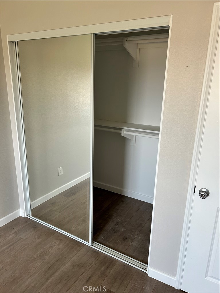 13665 Arrow Route, Unit 9 Fontana, CA 92335 - Photo 24 of 43 an empty room with wooden floor