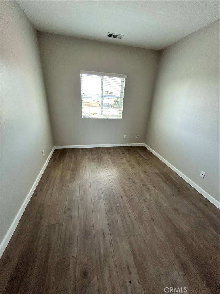 13665 Arrow Route, Unit 9 Fontana, CA 92335 - Photo 26 of 43 wooden floor in an empty room with a window