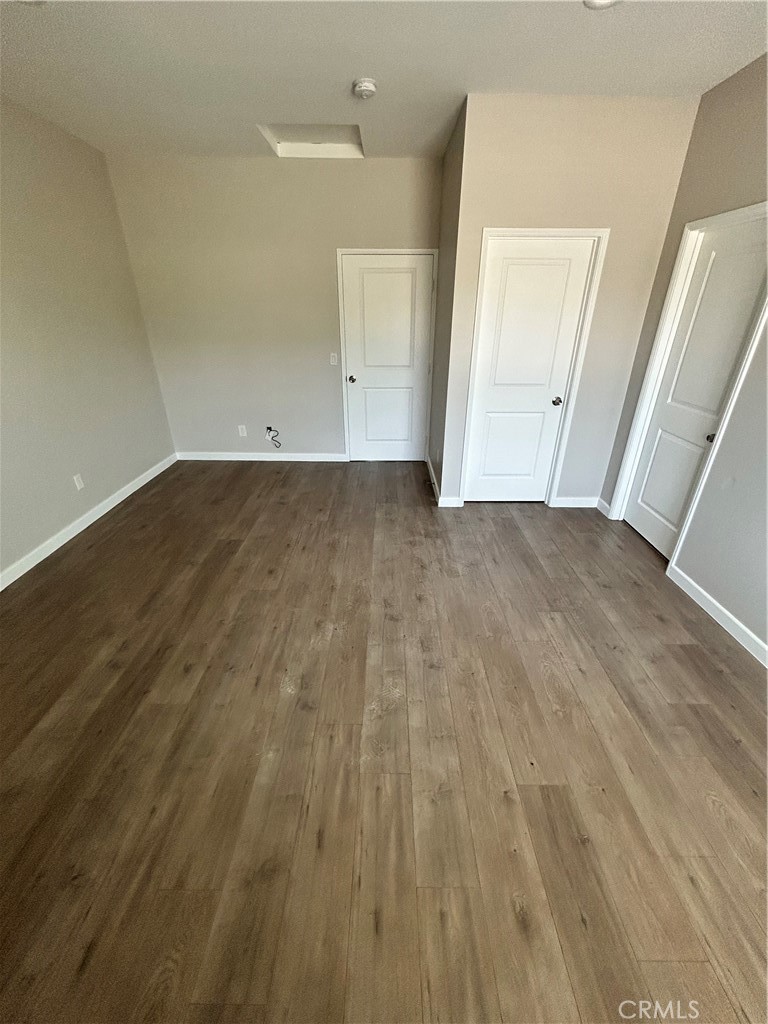 13665 Arrow Route, Unit 9 Fontana, CA 92335 - Photo 27 of 43 an empty room with wooden floor and closet