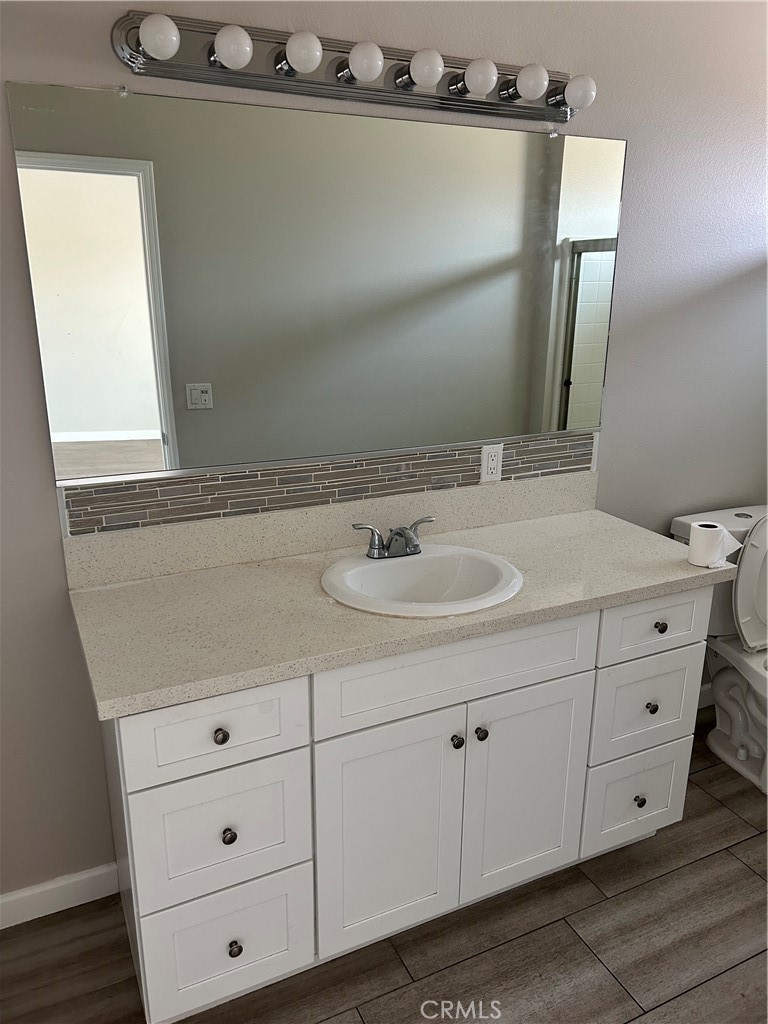 13665 Arrow Route, Unit 9 Fontana, CA 92335 - Photo 28 of 43 a bathroom with a sink and mirror
