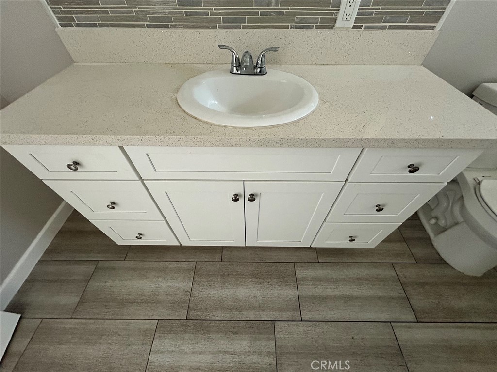 13665 Arrow Route, Unit 9 Fontana, CA 92335 - Photo 29 of 43 a bathroom with a sink and a mirror