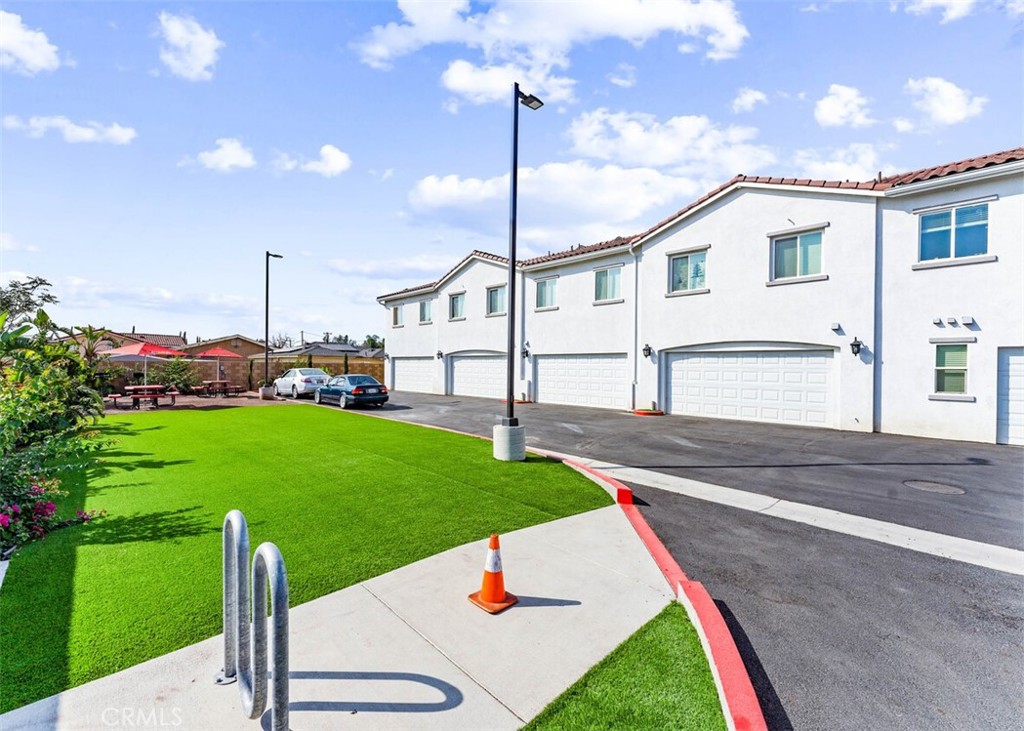 13665 Arrow Route, Unit 9 Fontana, CA 92335 - Photo 37 of 43 a front view of a house with a yard