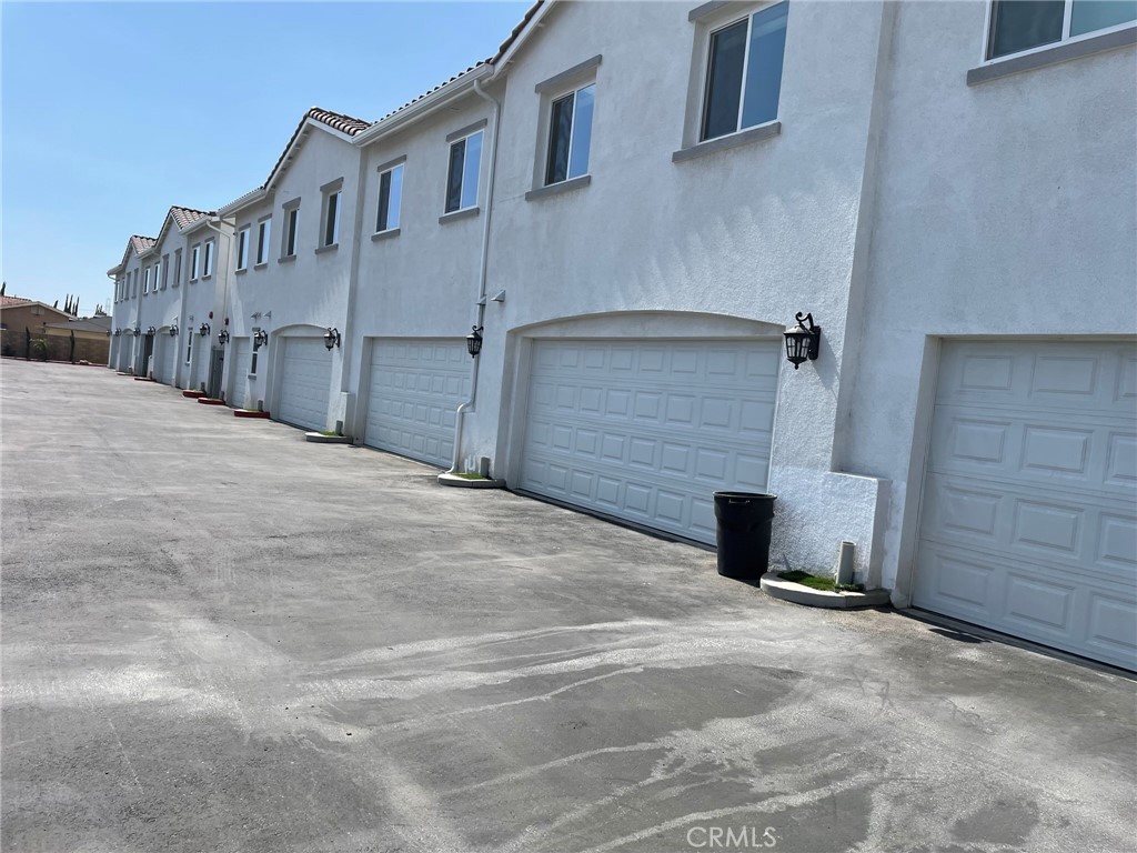 13665 Arrow Route, Unit 9 Fontana, CA 92335 - Photo 42 of 43 a view of a house with a wooden fence