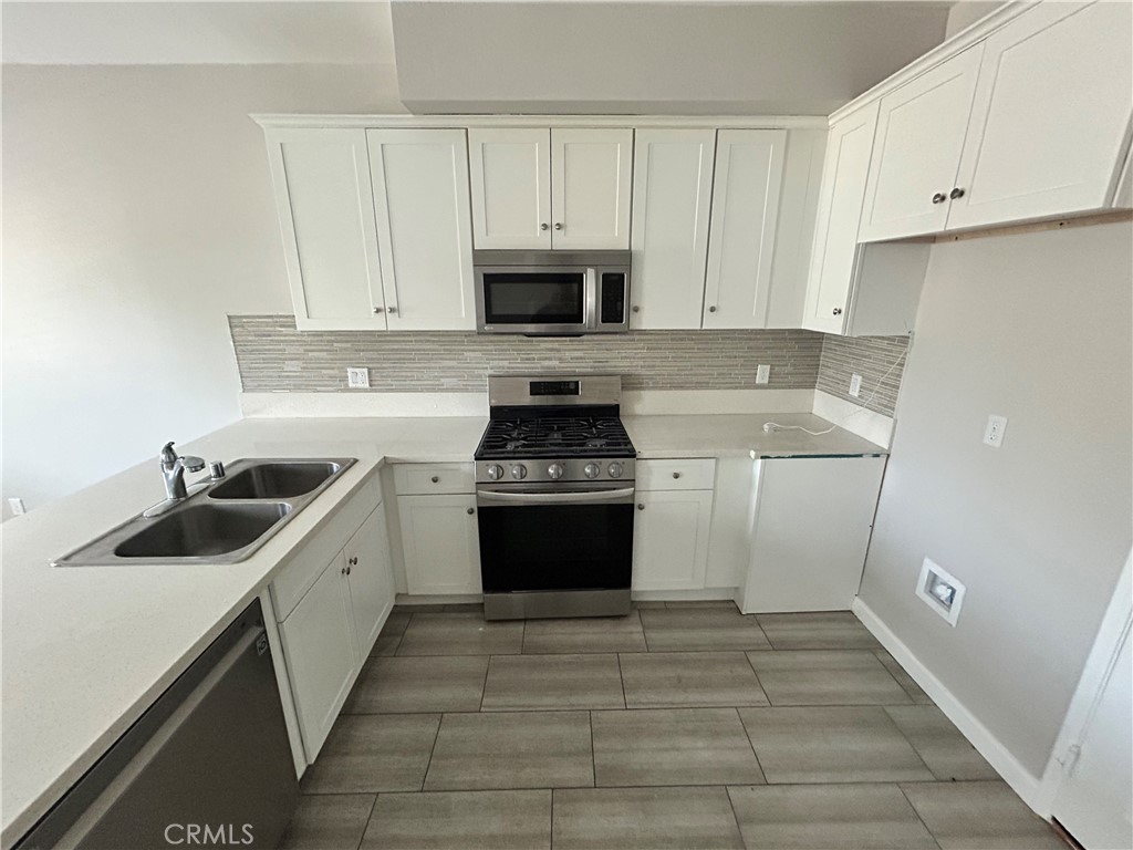 13665 Arrow Route, Unit 9 Fontana, CA 92335 - Photo 6 of 43 a kitchen with a sink stove and cabinets