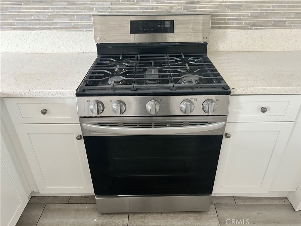 13665 Arrow Route, Unit 9 Fontana, CA 92335 - Photo 8 of 43 a stove top oven sitting inside of a kitchen