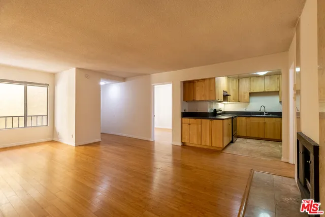 a view of kitchen with kitchen island and stainless steel appliances