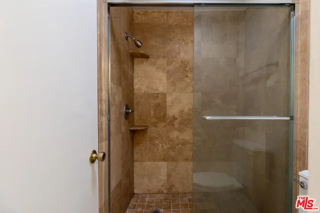 a bathroom with a glass door shower