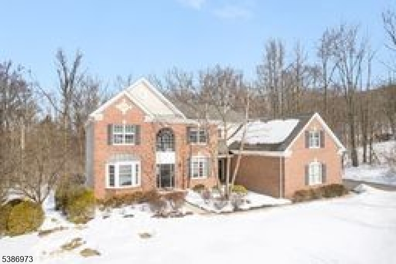a view of a house with a yard covered in snow