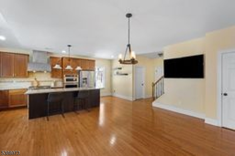 33 Chancellor Way Long Valley, NJ 07853 - Photo 12 of 42 a kitchen with stainless steel appliances kitchen island granite countertop a refrigerator a stove top oven a sink with island and chairs