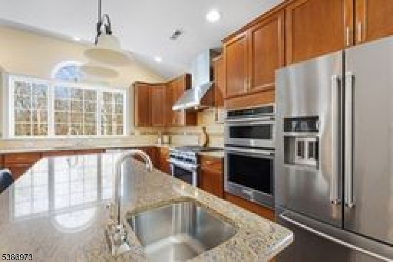 33 Chancellor Way Long Valley, NJ 07853 - Photo 13 of 42 a kitchen with stainless steel appliances granite countertop a refrigerator a stove and a sink with wooden floors