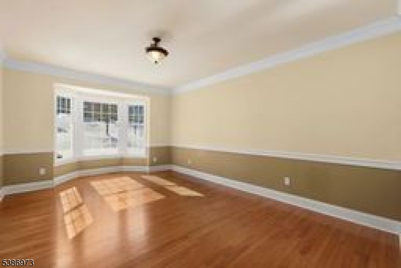 33 Chancellor Way Long Valley, NJ 07853 - Photo 16 of 42 an empty room with wooden floor and windows