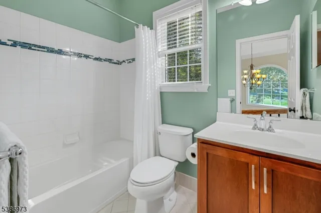 a spacious bathroom with a double vanity sink mirror and a bathtub