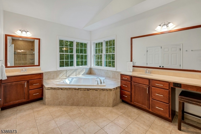 33 Chancellor Way Long Valley, NJ 07853 - Photo 24 of 42 a spacious bathroom with a tub a sink and mirror
