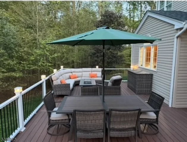 a backyard of a house with yard and outdoor seating