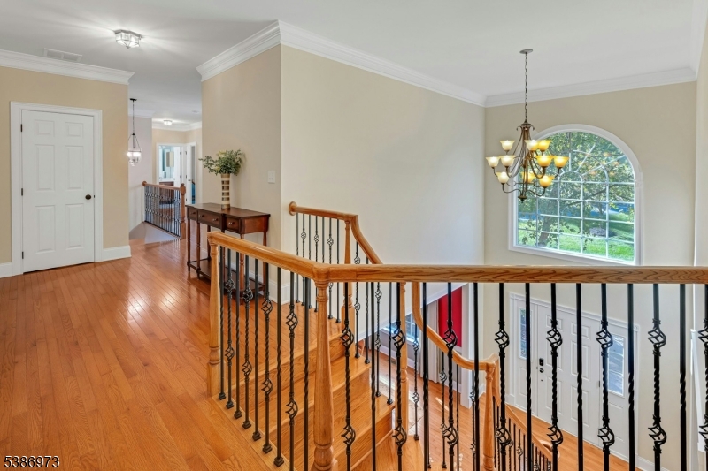 33 Chancellor Way Long Valley, NJ 07853 - Photo 5 of 42 a view of hallway with wooden floor and chandelier