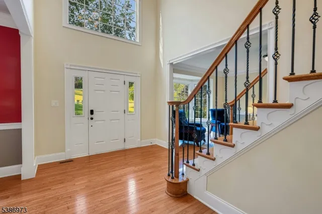 a view of entryway and hall with wooden floor