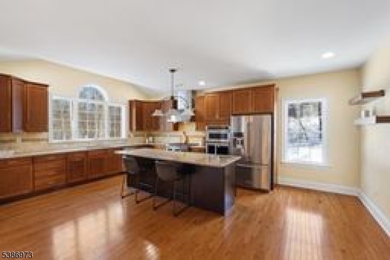 33 Chancellor Way Long Valley, NJ 07853 - Photo 10 of 42 a kitchen with stainless steel appliances granite countertop a refrigerator a sink dishwasher a stove and a dining table with wooden floor