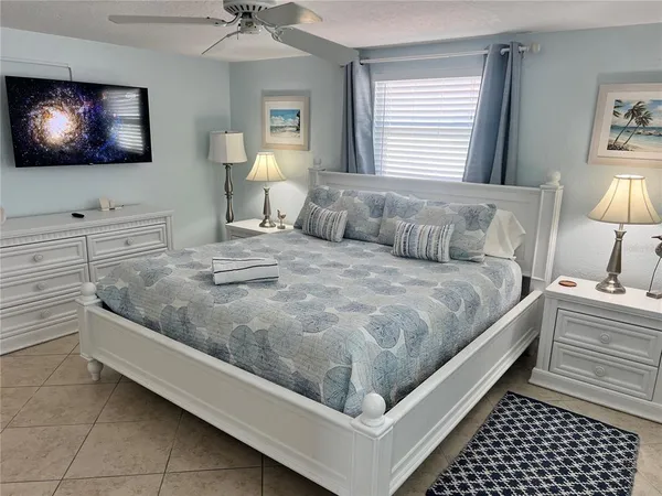 a bedroom with a bed and a flat screen tv