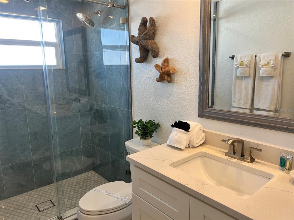 6154 Midnight Pass Road, Unit B11 Sarasota, FL 34242 - Photo 12 of 15 a bathroom with a sink toilet and shower