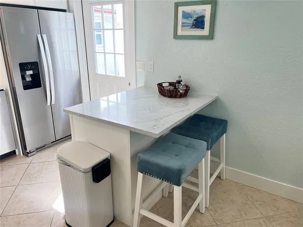 a kitchen with stainless steel appliances a microwave a refrigerator and a stove