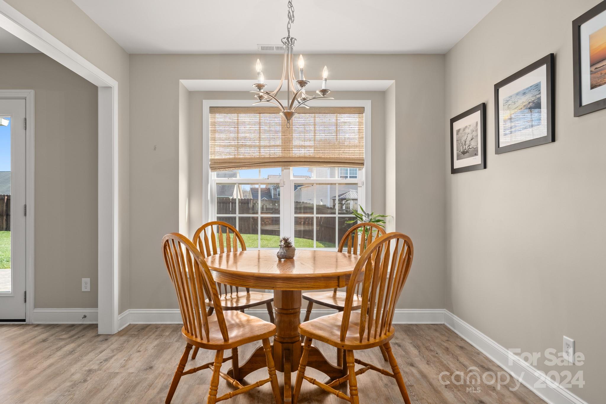 290 West Swift Creek Road Fletcher, NC 28732 - Photo 7 of 33 a dining room with furniture a chandelier and wooden floor