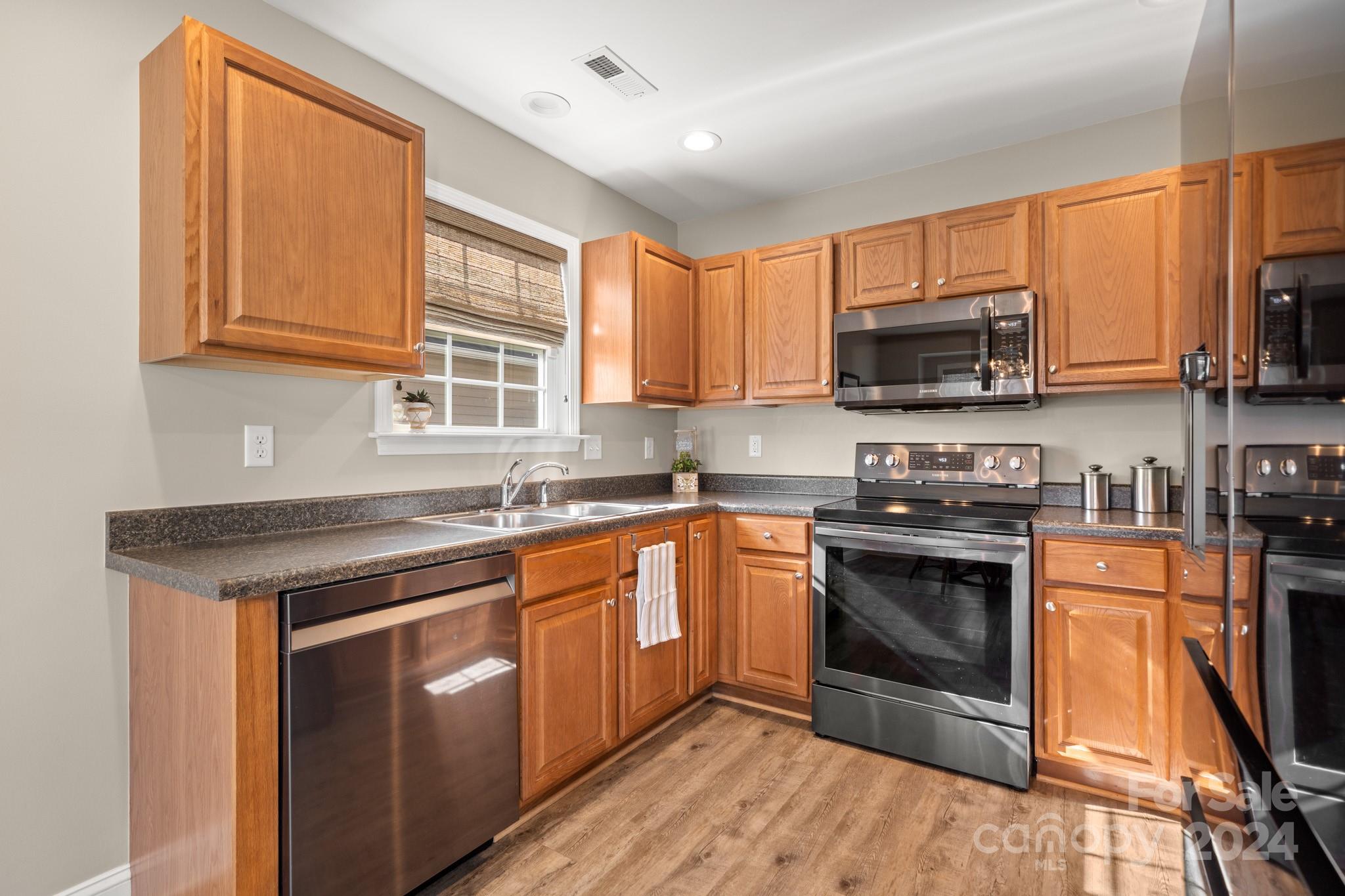 290 West Swift Creek Road Fletcher, NC 28732 - Photo 8 of 33 a kitchen with stainless steel appliances granite countertop a stove sink microwave and window