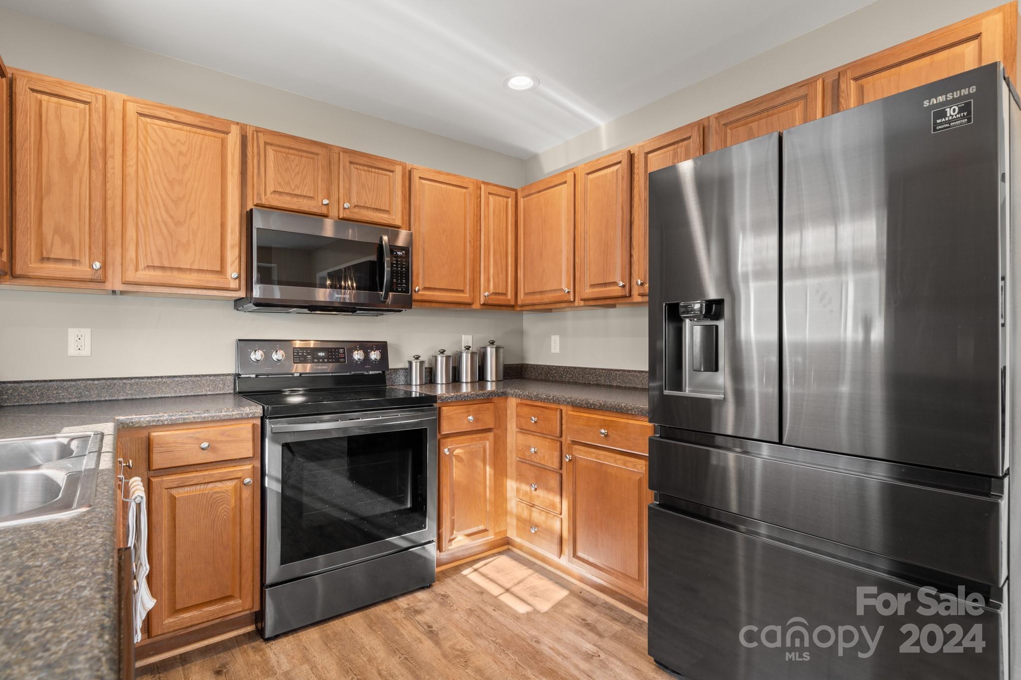 290 West Swift Creek Road Fletcher, NC 28732 - Photo 10 of 33 a kitchen with stainless steel appliances granite countertop a refrigerator stove and microwave