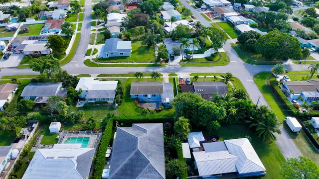 an aerial view of a house with a yard and lake view
