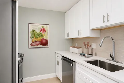 a stove top oven sitting inside of a kitchen