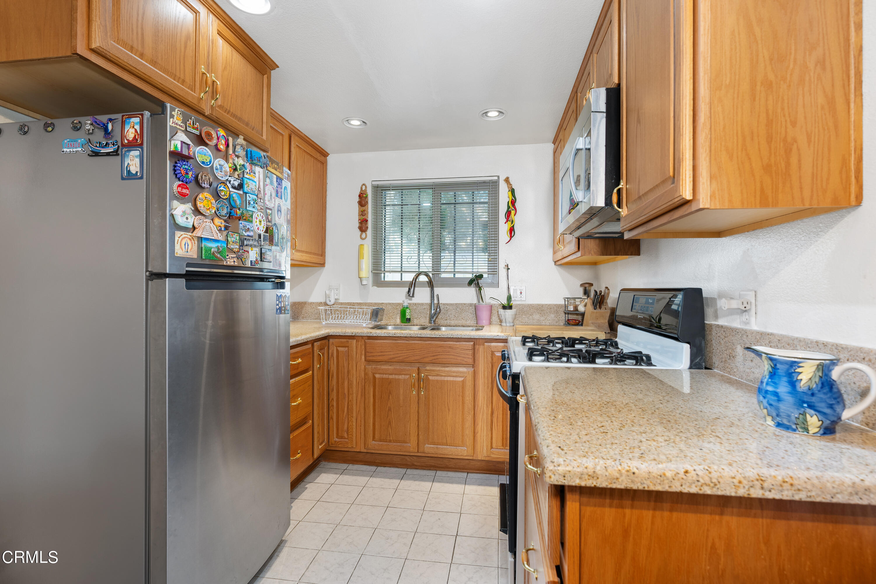 5170 North River Road, Unit C Oceanside, CA 92057 - Photo 14 of 43 a kitchen with stainless steel appliances granite countertop a refrigerator sink and stove
