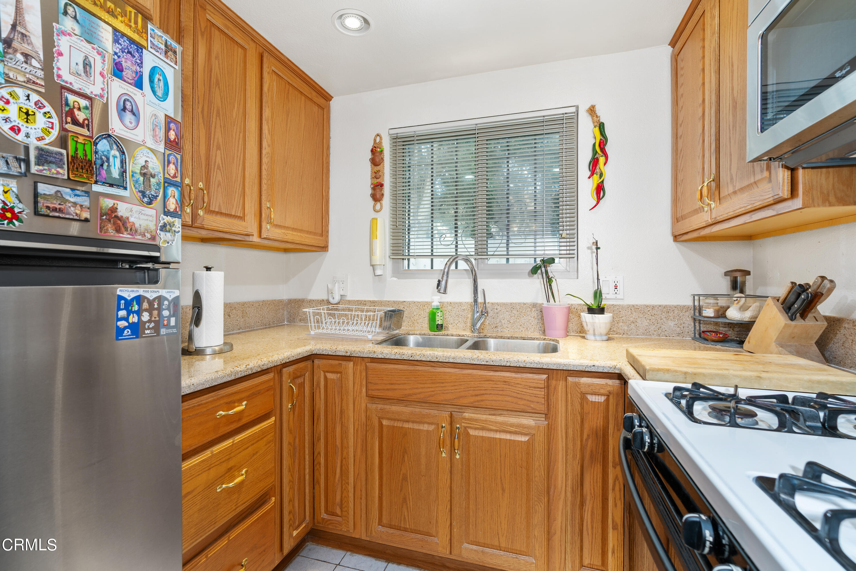 5170 North River Road, Unit C Oceanside, CA 92057 - Photo 15 of 43 a kitchen with stainless steel appliances granite countertop a sink stove and refrigerator