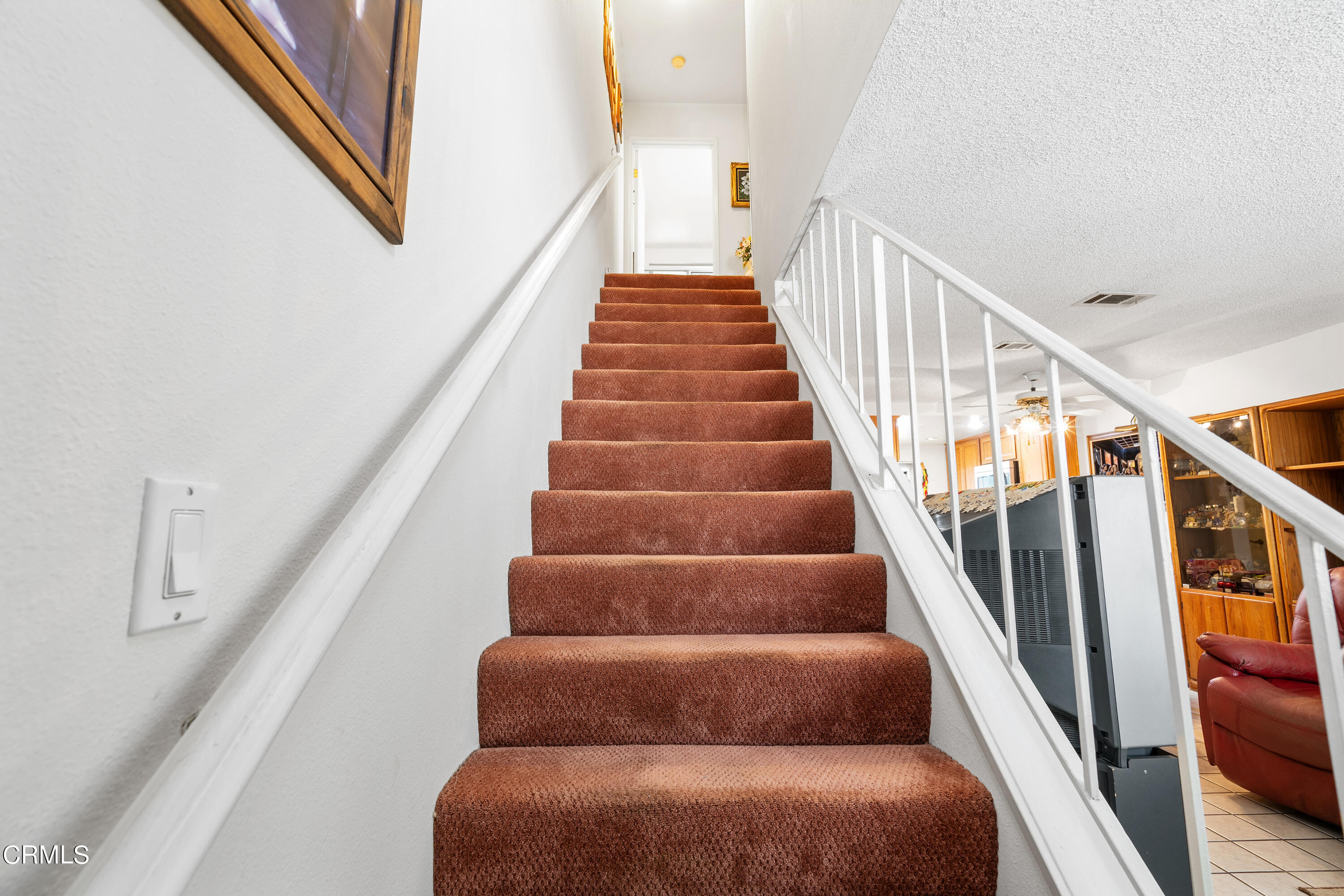 5170 North River Road, Unit C Oceanside, CA 92057 - Photo 17 of 43 a view of staircase with wooden floor and white walls