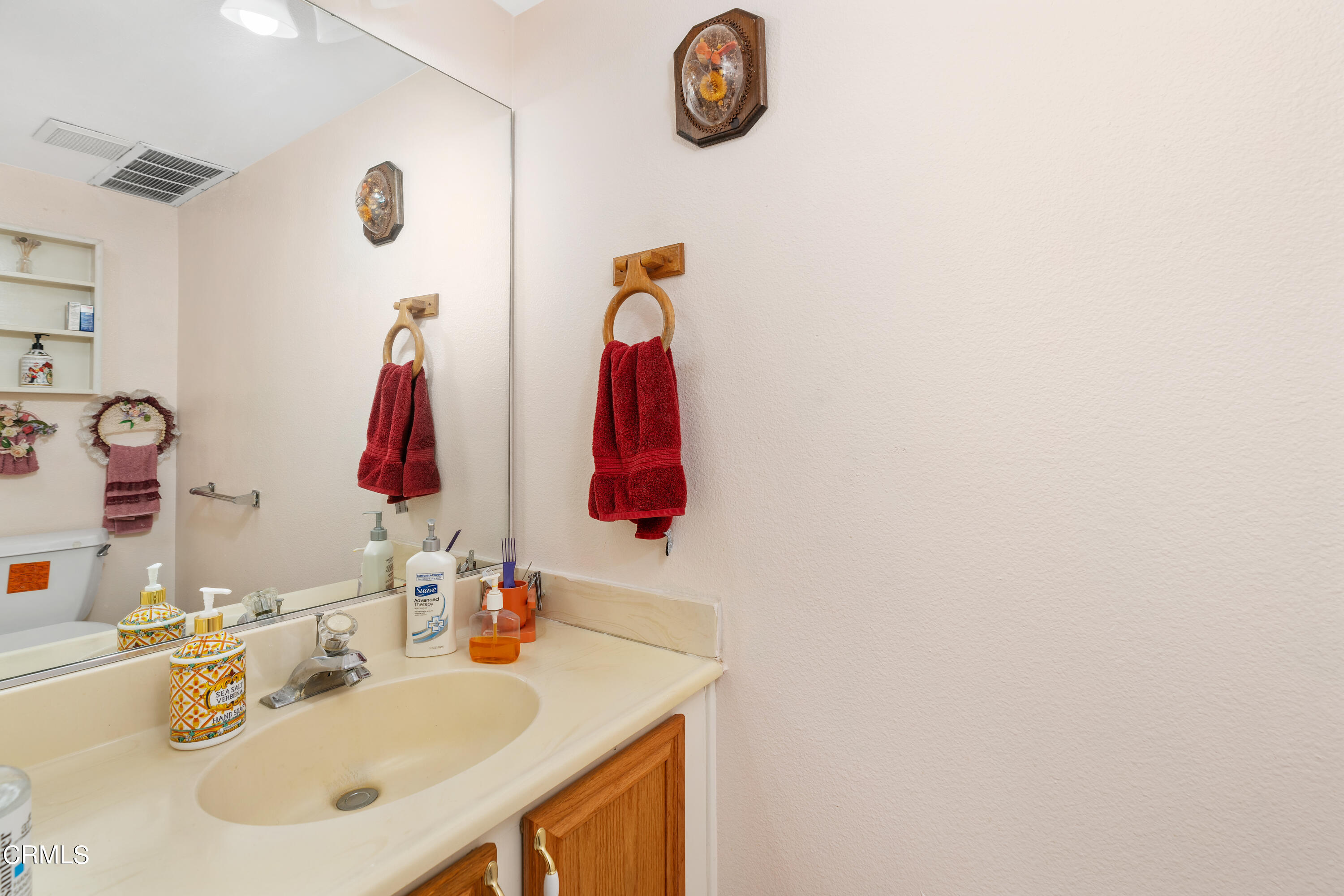 5170 North River Road, Unit C Oceanside, CA 92057 - Photo 19 of 43 a bathroom with a sink and a mirror