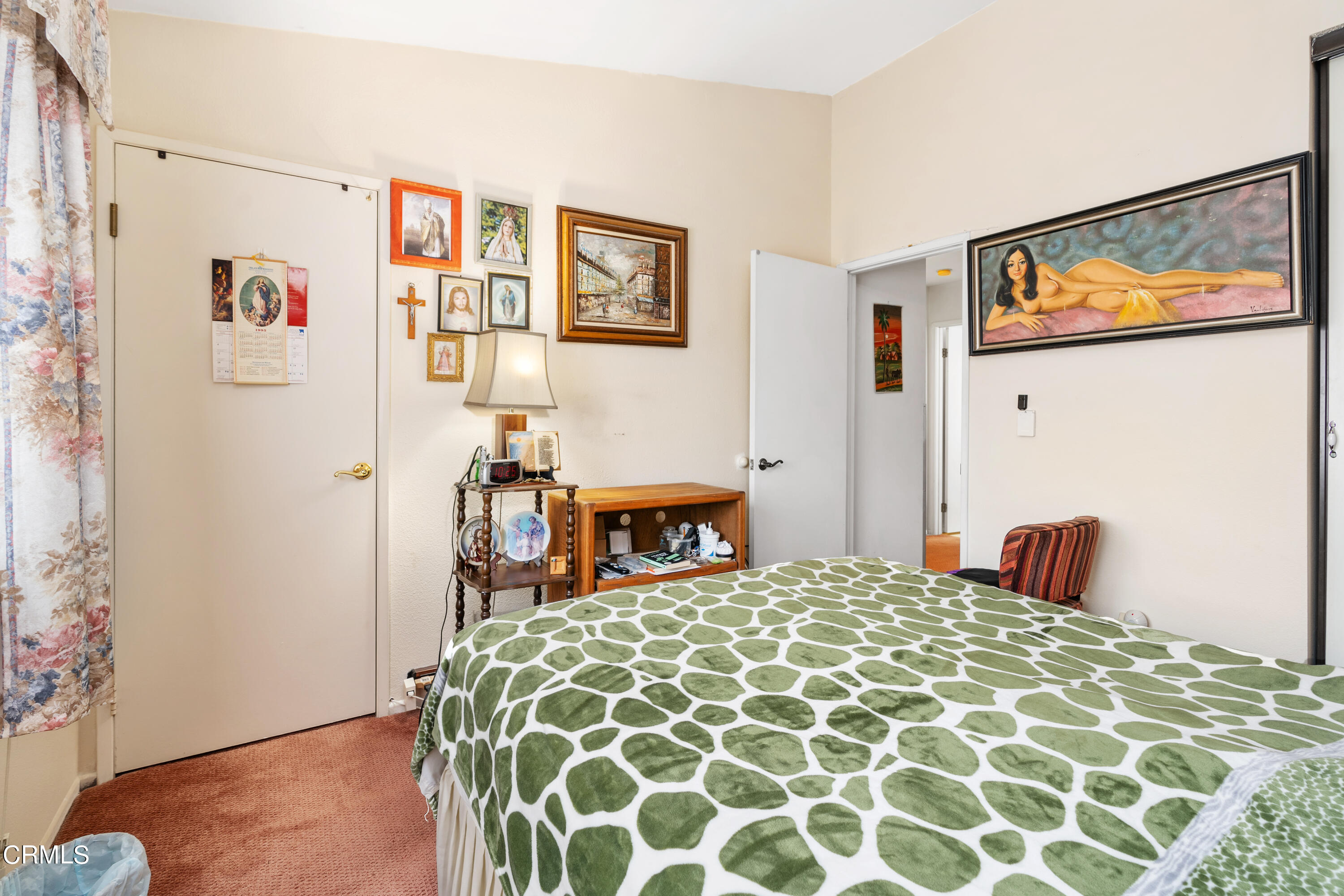 5170 North River Road, Unit C Oceanside, CA 92057 - Photo 22 of 43 a bedroom with a large bed and a chandelier