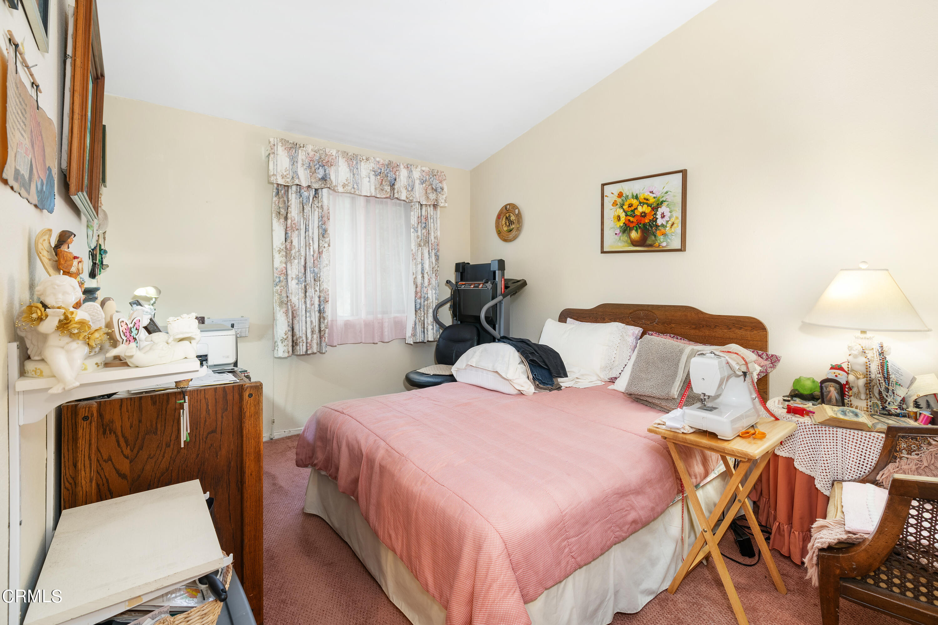 5170 North River Road, Unit C Oceanside, CA 92057 - Photo 24 of 43 a bedroom with a bed and a table