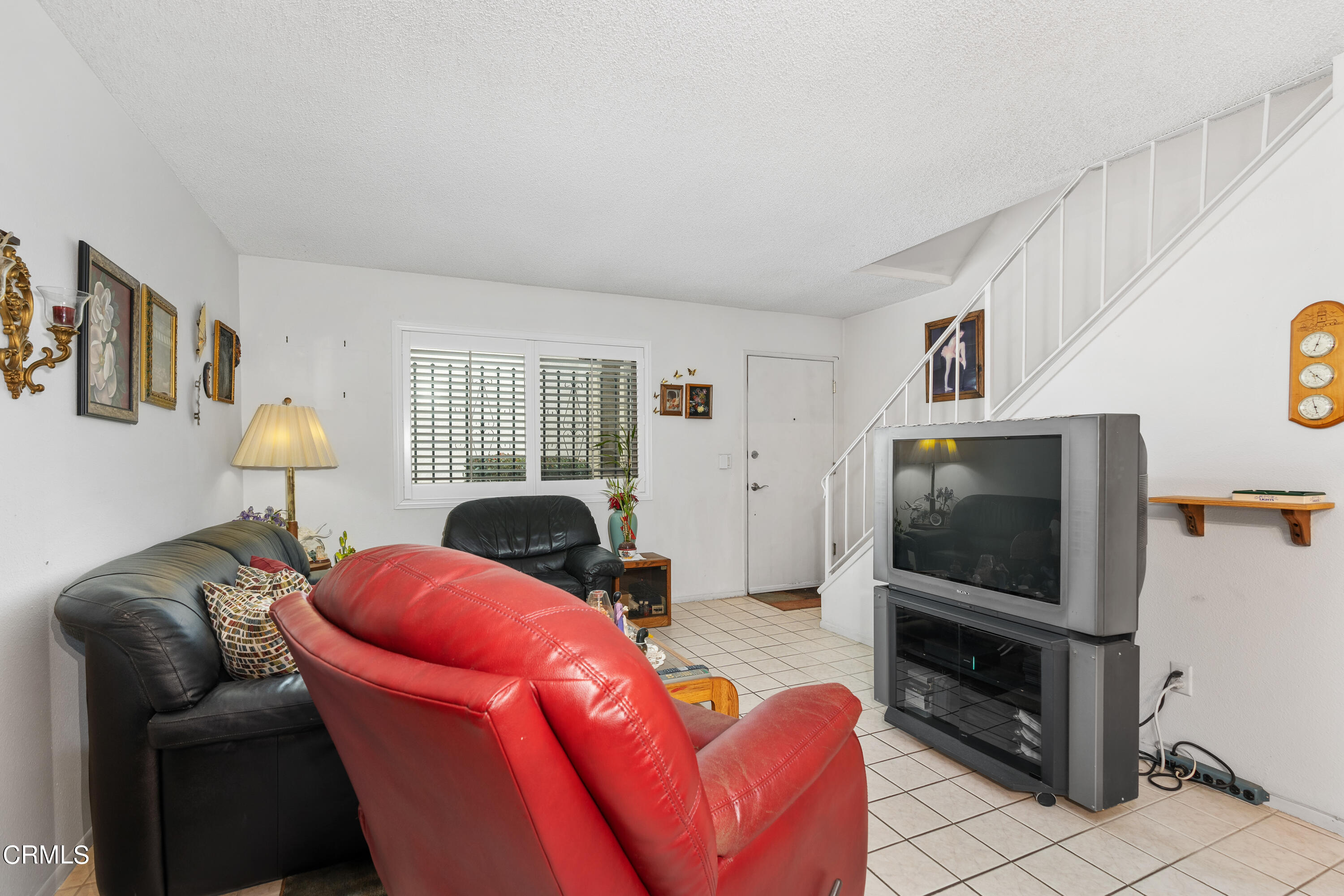 5170 North River Road, Unit C Oceanside, CA 92057 - Photo 7 of 43 a living room with furniture and a flat screen tv