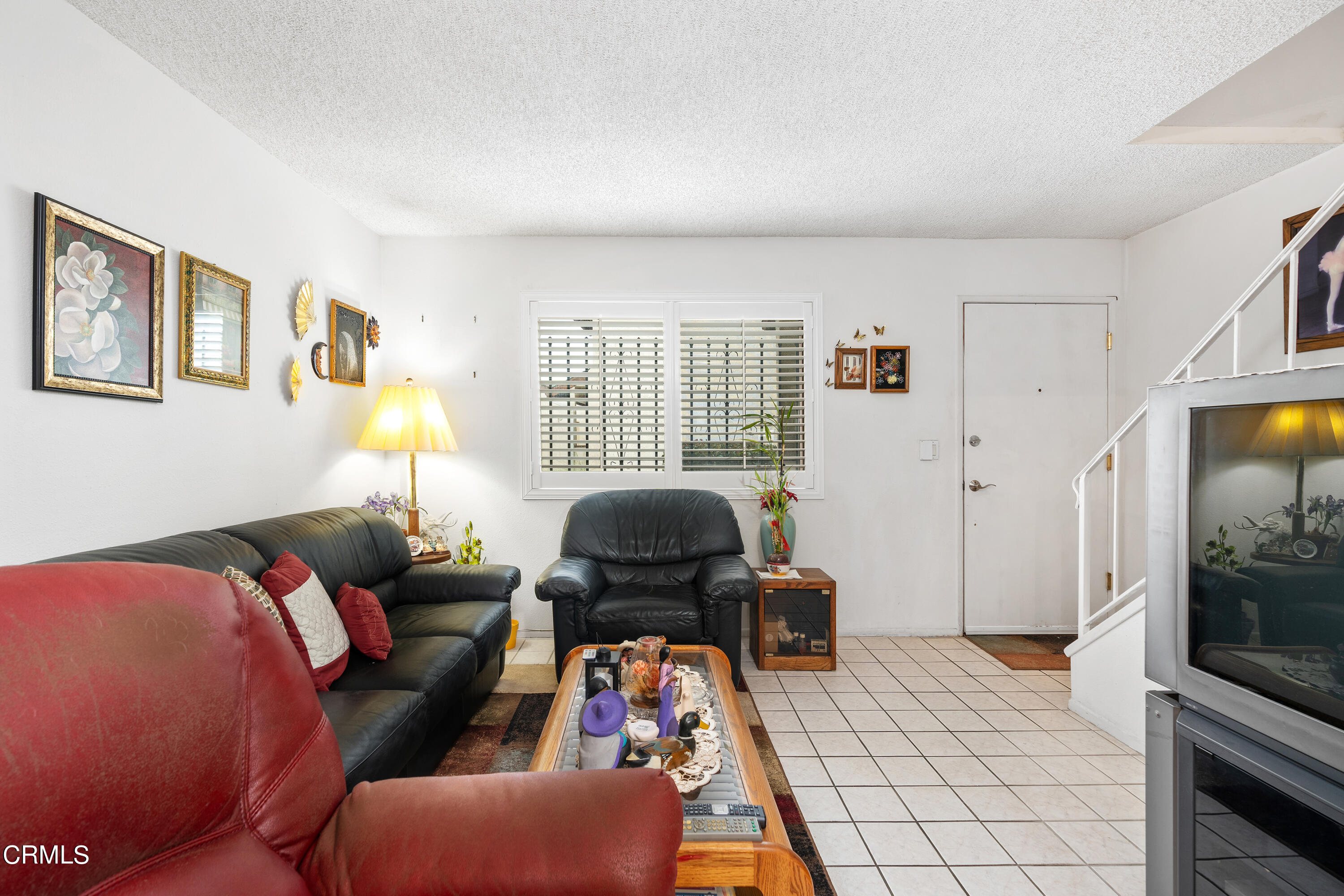 5170 North River Road, Unit C Oceanside, CA 92057 - Photo 8 of 43 a living room with furniture and a flat screen tv